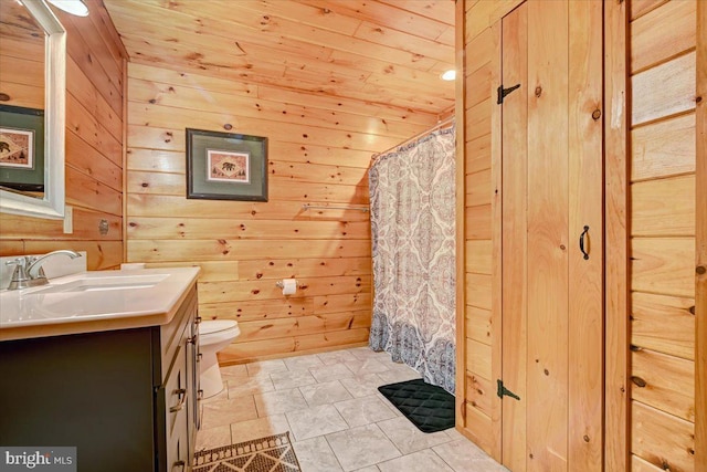 bathroom featuring wooden walls, vanity, and wooden ceiling