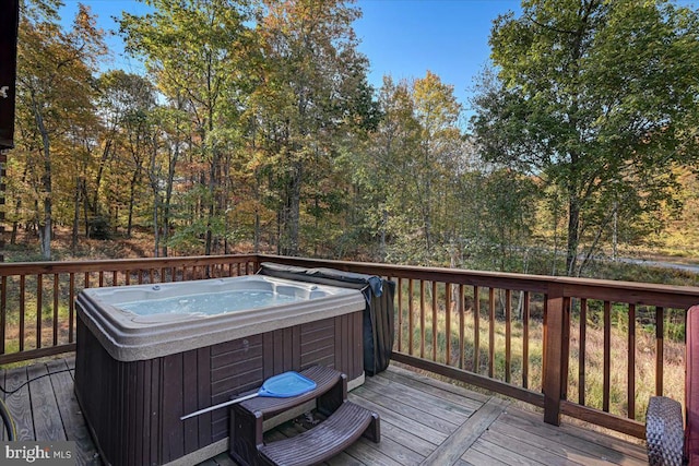 wooden deck with a hot tub