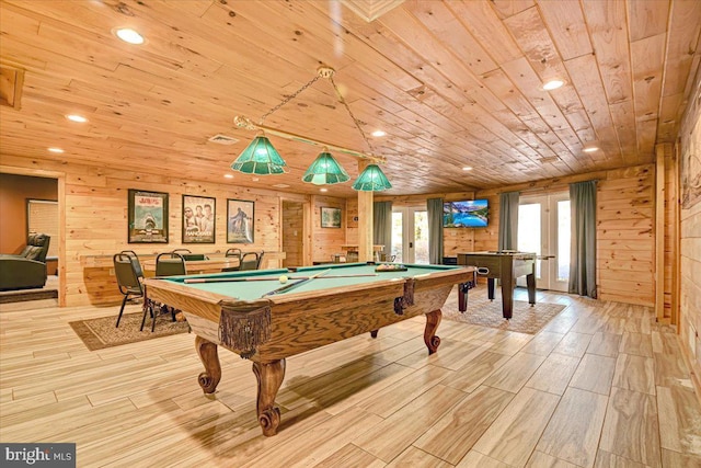 game room featuring wood walls, light wood-type flooring, wooden ceiling, and billiards