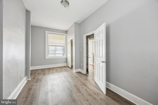 unfurnished bedroom with light wood-type flooring