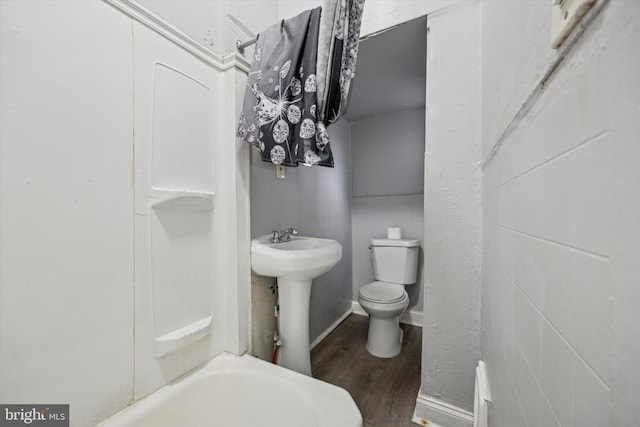 bathroom featuring hardwood / wood-style floors, sink, toilet, and tile walls