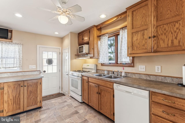 kitchen featuring ceiling fan, white appliances, and sink