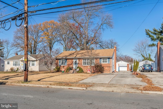 single story home with a garage and an outbuilding