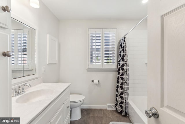 full bathroom featuring shower / bath combination with curtain, vanity, and toilet