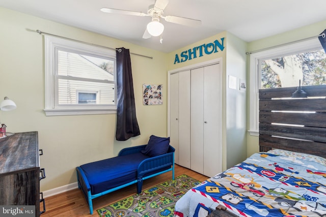 bedroom with hardwood / wood-style floors, ceiling fan, and a closet