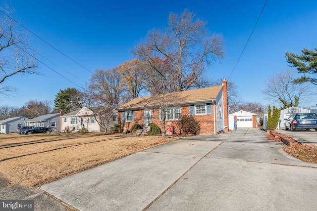 ranch-style home with an outbuilding, a front yard, and a garage