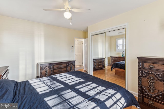 bedroom with light wood-type flooring, a closet, and ceiling fan