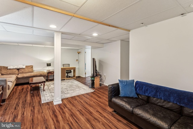 living room featuring hardwood / wood-style floors and a drop ceiling