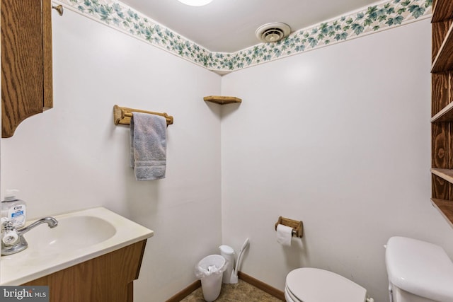 bathroom featuring vanity and toilet