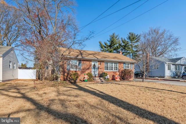 ranch-style home with a front lawn