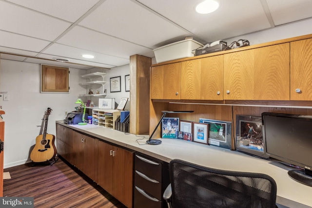 kitchen featuring dark hardwood / wood-style floors and a drop ceiling