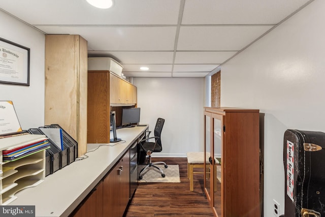 office with a drop ceiling and dark hardwood / wood-style floors