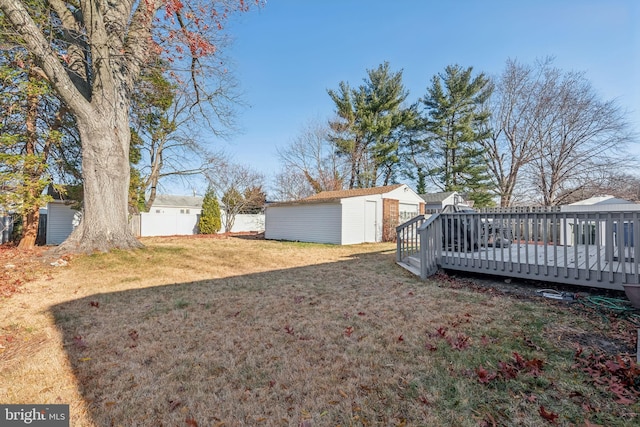 view of yard with a storage shed and a wooden deck