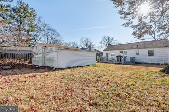 view of yard with an outbuilding and a wooden deck