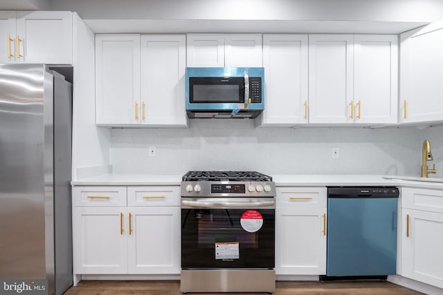 kitchen featuring white cabinets, dark hardwood / wood-style floors, sink, and appliances with stainless steel finishes