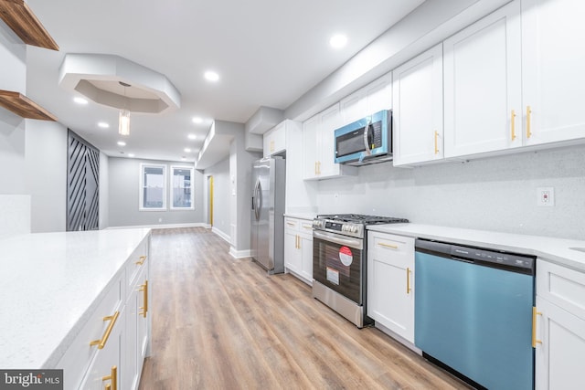 kitchen featuring white cabinets and appliances with stainless steel finishes