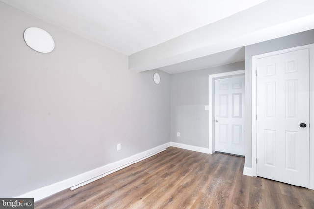 unfurnished room with dark hardwood / wood-style flooring