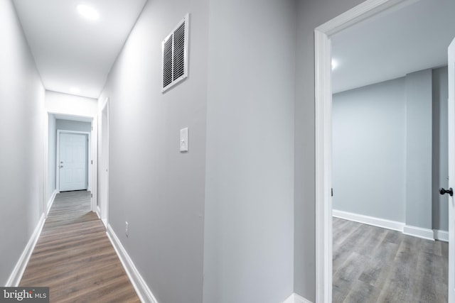 corridor with dark hardwood / wood-style floors