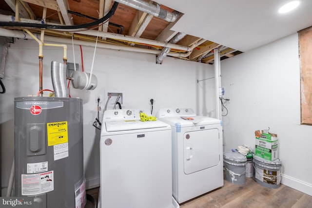 washroom featuring electric water heater, hardwood / wood-style floors, and independent washer and dryer