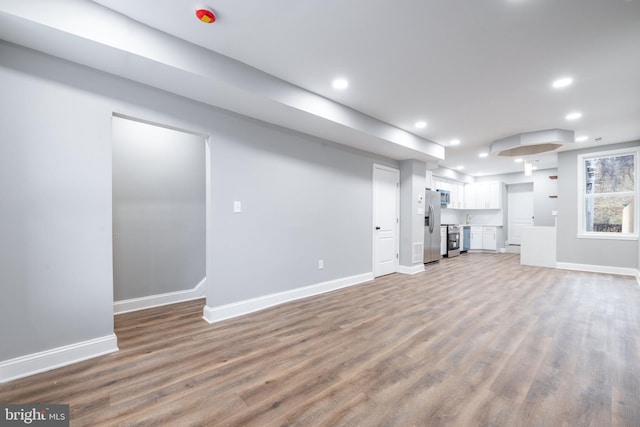 unfurnished living room with wood-type flooring