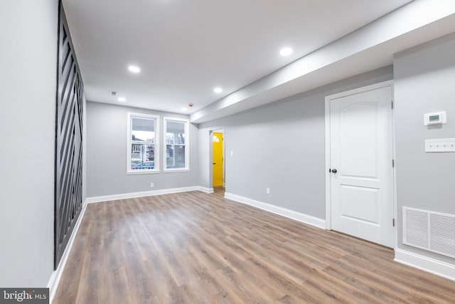 empty room with hardwood / wood-style flooring