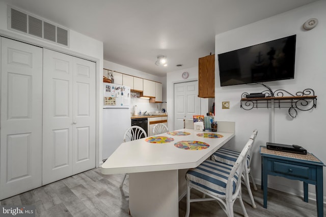 dining area featuring light wood-type flooring