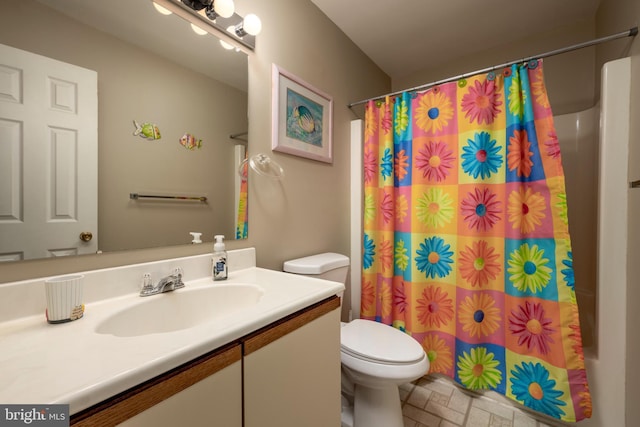 bathroom featuring vanity, toilet, and walk in shower