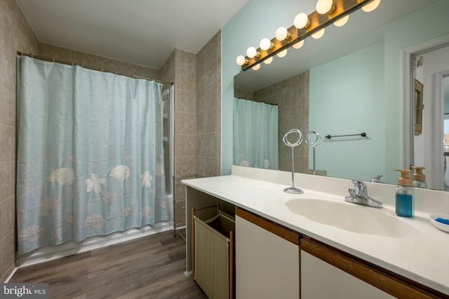 bathroom featuring shower / bathtub combination with curtain, vanity, and wood-type flooring