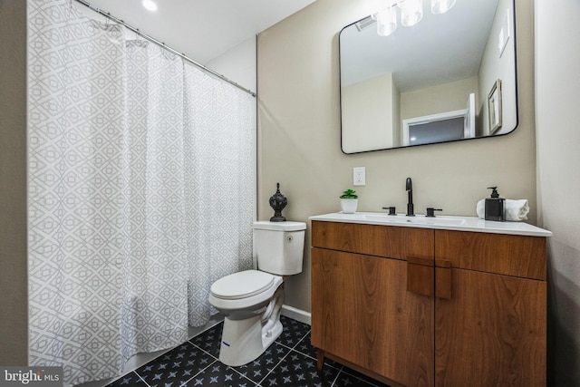 bathroom featuring tile patterned flooring, vanity, and toilet