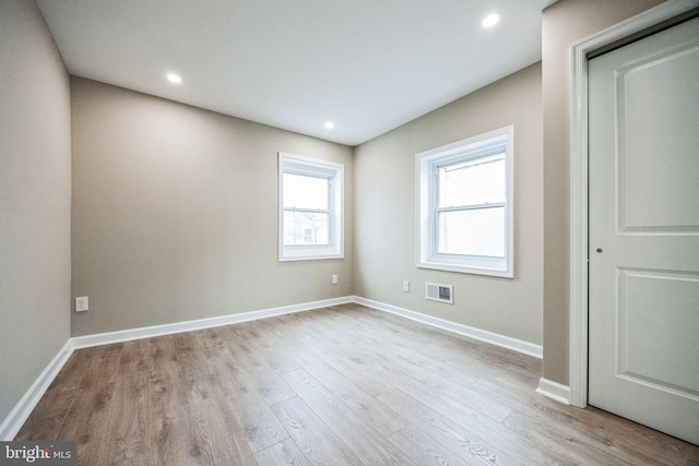 spare room featuring light hardwood / wood-style flooring