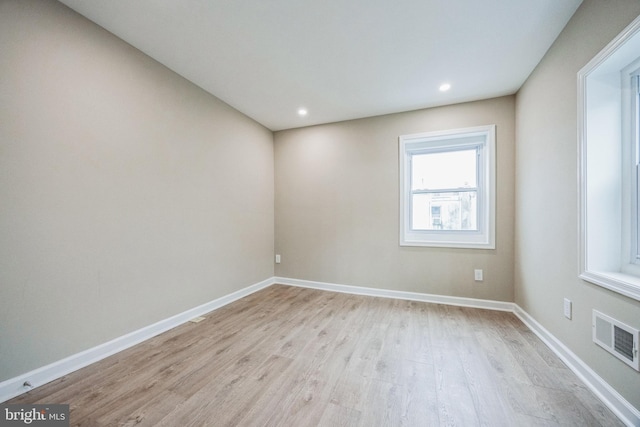 empty room with light hardwood / wood-style flooring