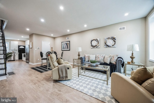 living room with light hardwood / wood-style flooring