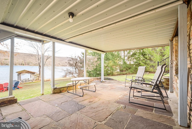 view of patio / terrace featuring a water and mountain view