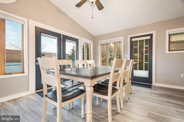 dining area with vaulted ceiling, light hardwood / wood-style flooring, ceiling fan, and a healthy amount of sunlight