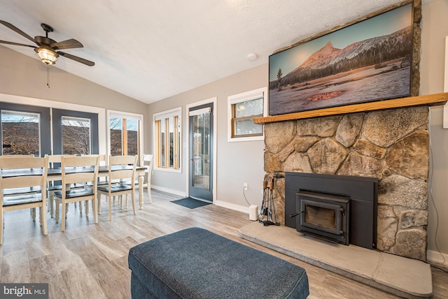 living room featuring hardwood / wood-style flooring, ceiling fan, and lofted ceiling