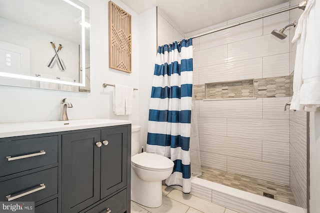 bathroom featuring tile patterned floors, toilet, vanity, and walk in shower