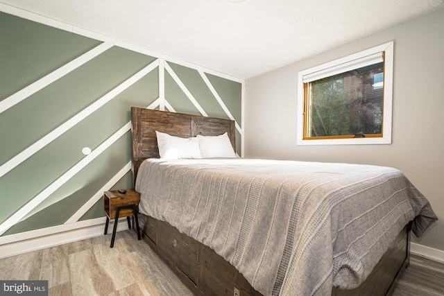 bedroom with hardwood / wood-style flooring