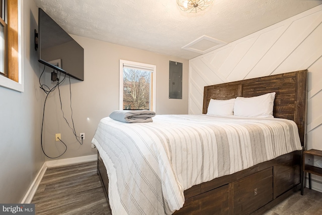 bedroom featuring a textured ceiling, electric panel, wooden walls, and dark hardwood / wood-style floors