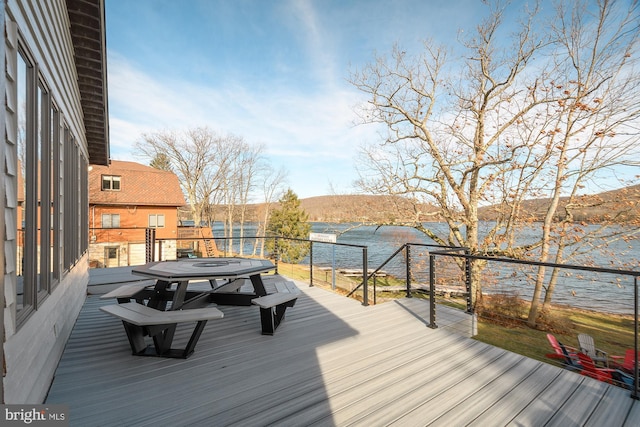 deck with a water and mountain view