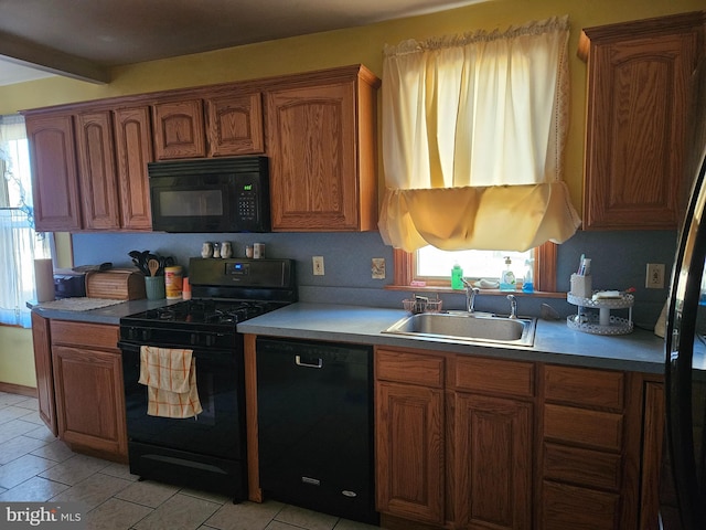 kitchen featuring beam ceiling, sink, a healthy amount of sunlight, and black appliances