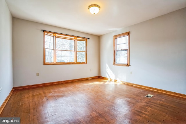 unfurnished room with hardwood / wood-style flooring