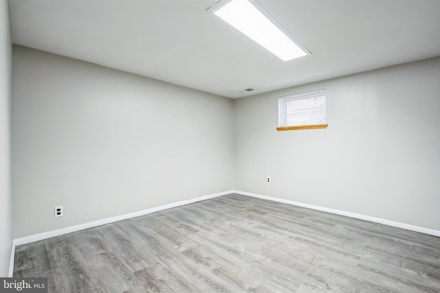 unfurnished room with light wood-type flooring