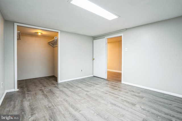 unfurnished bedroom featuring a closet and light hardwood / wood-style flooring