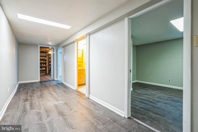 hallway with wood-type flooring