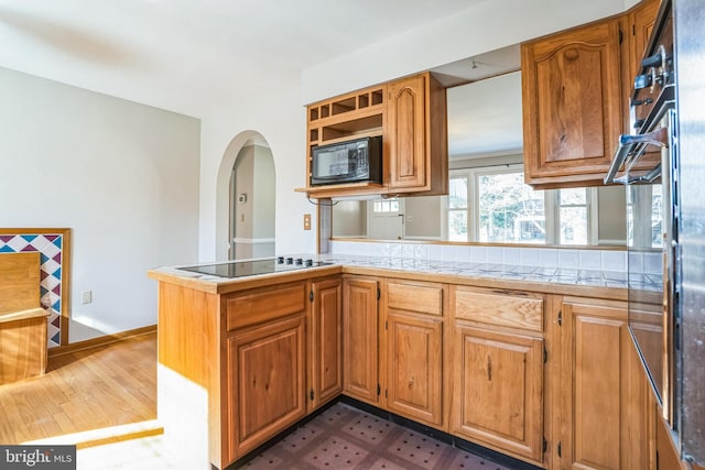 kitchen featuring kitchen peninsula and black appliances