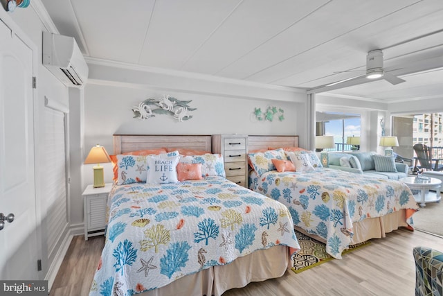 bedroom featuring ceiling fan, wood-type flooring, ornamental molding, and a wall unit AC