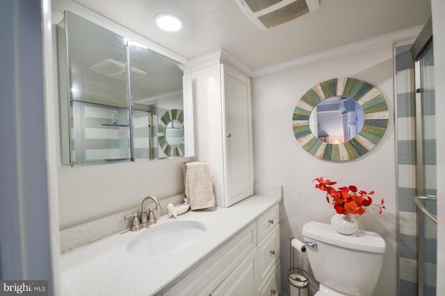 bathroom with vanity, toilet, ornamental molding, and walk in shower