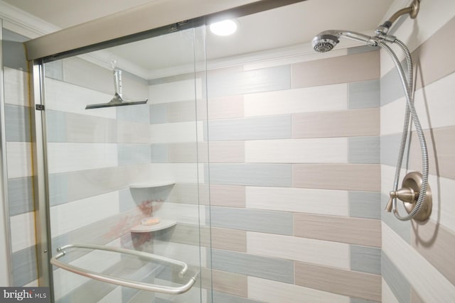 bathroom featuring ornamental molding and walk in shower