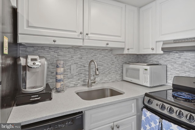 kitchen with electric range oven, white cabinetry, stainless steel dishwasher, and sink