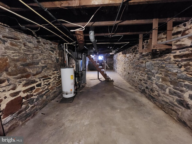 basement featuring gas water heater and heating unit